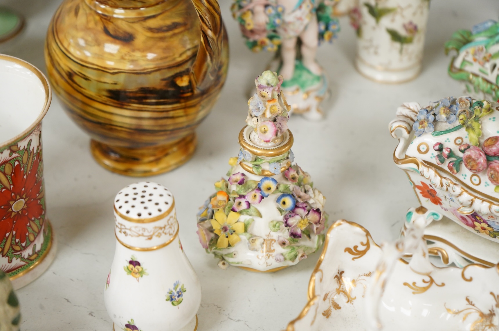 Large group of 19th/20th century English ceramics, to include a Rockingham basket, other English porcelain flower encrusted vessels, a Copeland and Garrett ewer, a Minton Sevres style beaker, a Wedgwood agate ware jug, R